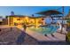 Spacious backyard featuring a swimming pool, covered patio, lush landscaping, and ample space for outdoor activities at 603 W Keats Ave, Mesa, AZ 85210