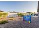 Spacious backyard featuring gravel, a Connect Four game, trees and other games at 603 W Keats Ave, Mesa, AZ 85210