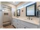 Modern bathroom with double sinks, large mirrors, and a shower area at 603 W Keats Ave, Mesa, AZ 85210