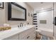 Bright bathroom with white cabinets, modern countertops, and a tub with stylish shower curtain at 603 W Keats Ave, Mesa, AZ 85210