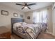 Cozy bedroom features a ceiling fan, floral bedding, and lots of natural light at 603 W Keats Ave, Mesa, AZ 85210