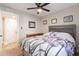 Bedroom with a ceiling fan, wood headboard and floral bedding at 603 W Keats Ave, Mesa, AZ 85210