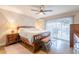 Bright bedroom with a large bed, ceiling fan, and sliding glass doors to the outside at 603 W Keats Ave, Mesa, AZ 85210