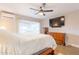 Comfortable bedroom with a ceiling fan, large window, TV, and furnishings at 603 W Keats Ave, Mesa, AZ 85210