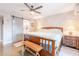 Bright bedroom with a large bed, ceiling fan, and sliding barn door to the bathroom at 603 W Keats Ave, Mesa, AZ 85210