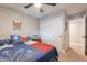 Comfortable bedroom featuring a ceiling fan, closet, and doorway to another room at 603 W Keats Ave, Mesa, AZ 85210