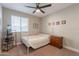 Bedroom features a ceiling fan, white metal frame bed and natural lighting at 603 W Keats Ave, Mesa, AZ 85210