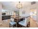 Open dining room with updated light fixture, wood-look tile floors at 603 W Keats Ave, Mesa, AZ 85210