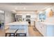 Bright updated kitchen featuring white cabinets, quartz countertops, stainless steel appliances, and a center island with seating at 603 W Keats Ave, Mesa, AZ 85210