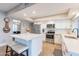 Bright updated kitchen with white cabinets, stainless steel appliances, quartz countertops, and wood-look flooring at 603 W Keats Ave, Mesa, AZ 85210