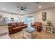 Spacious living room with leather seating, wood-look floors, open to the kitchen and back yard at 603 W Keats Ave, Mesa, AZ 85210