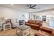 Bright living room with leather seating, wood-look floors, open to the adjacent kitchen at 603 W Keats Ave, Mesa, AZ 85210