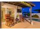 Cozy outdoor patio features comfortable rocking chairs, a view of the pool, and a tranquil setting, perfect for relaxation at 603 W Keats Ave, Mesa, AZ 85210
