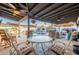 Inviting covered patio with dining and lounge area overlooking the pool and backyard at 603 W Keats Ave, Mesa, AZ 85210