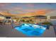Beautiful pool and patio area under a colorful sunset with room for sitting at 603 W Keats Ave, Mesa, AZ 85210