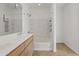 Clean, bright bathroom featuring a double sink vanity and shower-tub combo with built-in shelving at 610 E Roosevelt St # 145, Phoenix, AZ 85004