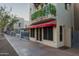 Charming building featuring a striped awning and second story balcony with greenery at 610 E Roosevelt St # 145, Phoenix, AZ 85004