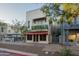 Stylish commercial building with second story balcony adorned with vibrant green plants at 610 E Roosevelt St # 145, Phoenix, AZ 85004