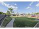 Well-maintained grassy area featuring a walking path and mature trees, creating a serene outdoor space at 610 E Roosevelt St # 145, Phoenix, AZ 85004