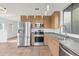 This kitchen boasts stainless steel appliances, wood cabinets, gray countertops and tile floors at 610 E Roosevelt St # 145, Phoenix, AZ 85004