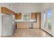 Kitchen with stainless steel appliances, wood cabinets, gray countertops, tile floors and patio access at 610 E Roosevelt St # 145, Phoenix, AZ 85004