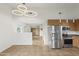 Open living space leading to kitchen featuring tile floors, windows and adjacent closet at 610 E Roosevelt St # 145, Phoenix, AZ 85004