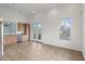 Open living space with tile floors, windows with exterior views and adjacent kitchen at 610 E Roosevelt St # 145, Phoenix, AZ 85004