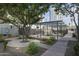 Community park area with shaded seating, manicured landscaping, and mature trees for relaxation and recreation at 610 E Roosevelt St # 145, Phoenix, AZ 85004