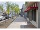 Commercial building street view along sidewalk with trees and parallel parked cars at 610 E Roosevelt St # 145, Phoenix, AZ 85004