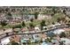 This aerial shot shows a neighborhood with homes, pools, streets and a golf course at 619 S Essex Ln, Mesa, AZ 85208