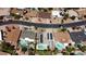 Birds eye view of houses, pools, solar, and local road, in residential community at 619 S Essex Ln, Mesa, AZ 85208