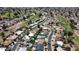 Overhead view of neighborhood community with homes, swimming pools, and a nearby golf course at 619 S Essex Ln, Mesa, AZ 85208