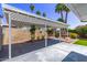 Covered patio and lush greenery in a private backyard at 619 S Essex Ln, Mesa, AZ 85208