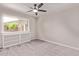 Neutrally painted bedroom with soft carpet, fan, and natural light at 619 S Essex Ln, Mesa, AZ 85208