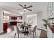 Dining room featuring a round table for four, hardwood flooring and access to kitchen at 619 S Essex Ln, Mesa, AZ 85208