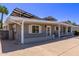 View of the home's side featuring solar panels, white trim, desert landscaping, and a spacious driveway at 619 S Essex Ln, Mesa, AZ 85208
