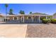 Charming single-story home featuring desert landscaping, covered porch, and shade awnings at 619 S Essex Ln, Mesa, AZ 85208