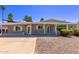 Charming single-story home featuring desert landscaping, covered porch, and shade awnings at 619 S Essex Ln, Mesa, AZ 85208