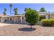 Charming single-story home featuring desert landscaping, covered porch, and shade awnings at 619 S Essex Ln, Mesa, AZ 85208