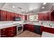 Cherry cabinets and stainless steel appliances highlight this beautifully renovated kitchen at 619 S Essex Ln, Mesa, AZ 85208