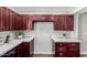 Spacious kitchen area with dark wood cabinets, white countertops, and modern fixtures at 619 S Essex Ln, Mesa, AZ 85208