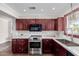 Updated kitchen featuring dark cabinetry, stainless steel appliances, and stylish hardware at 619 S Essex Ln, Mesa, AZ 85208