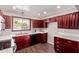 Well-lit kitchen featuring dark cabinets, white countertops and hardwood flooring at 619 S Essex Ln, Mesa, AZ 85208