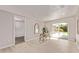 Bright living room featuring light wood floors, a desk, and sliding glass doors to the backyard at 619 S Essex Ln, Mesa, AZ 85208