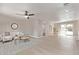 Bright living room with neutral decor, ceiling fan, and sliding glass doors to the backyard at 619 S Essex Ln, Mesa, AZ 85208