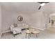 Bright living room with neutral decor, ceiling fan, and stylish coffee tables at 619 S Essex Ln, Mesa, AZ 85208
