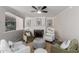 Cozy living room features a fireplace, plush seating, and a stylish ceiling fan at 619 S Essex Ln, Mesa, AZ 85208