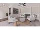 Bright living room featuring white armchairs, a fireplace, and hardwood flooring at 619 S Essex Ln, Mesa, AZ 85208