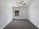 Neutral bedroom featuring carpet floors, a ceiling fan, and a window for natural lighting at 6255 S Opal Dr, Chandler, AZ 85249