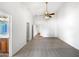 Large bedroom featuring neutral carpet, a ceiling fan, and attached bathroom and walk-in closets at 6255 S Opal Dr, Chandler, AZ 85249